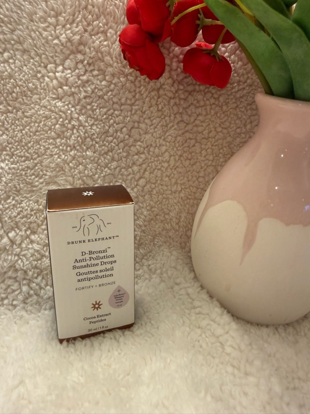 Drunk Elephant D-Bronzi Packaging with Bronze and White Accents